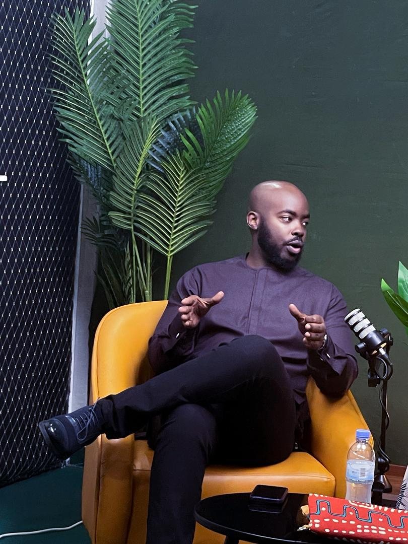 Joe Makuza speaking, seated in a studio
